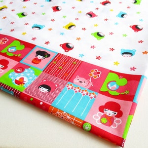 May include: White fabric with a repeating pattern of colorful cartoon faces and flowers. The bottom edge of the fabric features a patchwork design with red, pink, green, blue, and white squares. The squares feature a variety of patterns, including polka dots, stripes, and geometric designs.