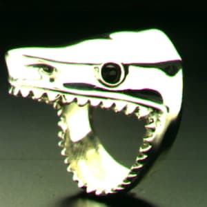 Shark ring, in sterling silver with black onyx eyes , or other colored stones. It is available in 4 basic sizes. Or custom sizes.