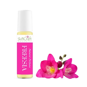 May include: A small glass bottle of SkinCraft Organics Freesia Natural Perfume. The bottle is clear and has a yellow liquid inside. The label is white with green text and a small green flower graphic. The text on the label reads "SkinCraft Organics" and "Natural Perfume Freesia".