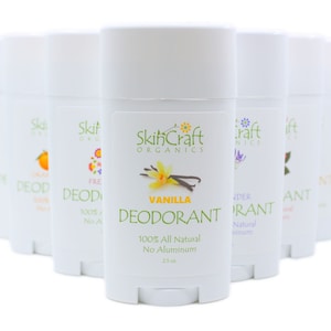 May include: A row of eight white deodorant sticks with different scents, including vanilla, lavender, and orange. The sticks are labeled "SkinCraft Organics" and say "100% All Natural No Aluminum".