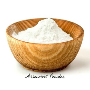 May include: A white powder, arrowroot powder, in a wooden bowl. The bowl is on a white background.