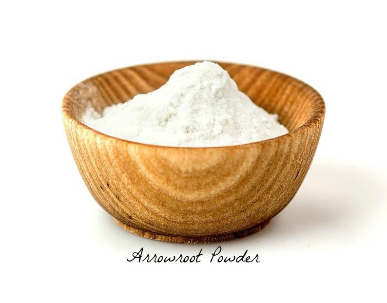 May include: A white powder, arrowroot powder, in a wooden bowl. The bowl is on a white background.