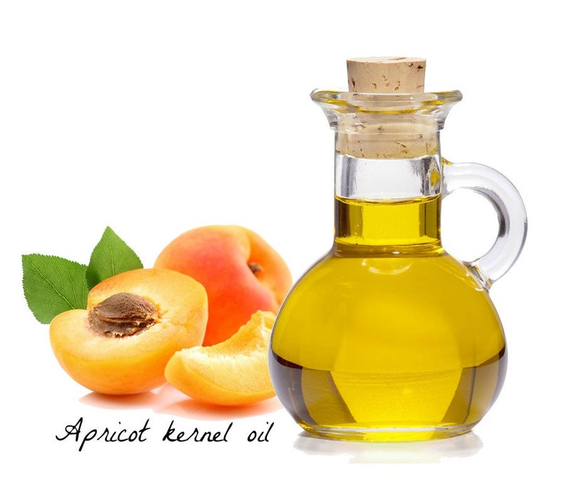 May include: A glass bottle with a cork stopper filled with golden yellow apricot kernel oil.  Three apricot halves are next to the bottle, two are whole and one is cut open.  The text "Apricot kernel oil" is written below the image.