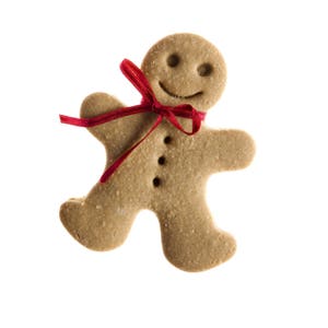 May include: A gingerbread man cookie with a red ribbon tied around its neck. The cookie has a smiling face and is decorated with white icing.
