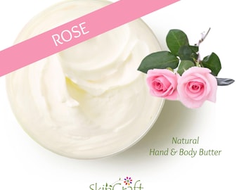 May include: A white bowl filled with a creamy, white hand and body butter. The bowl is on a white background. Two pink roses are in the top right corner of the image. The text "ROSE" is in the top left corner of the image. The text "Natural Hand & Body Butter" is in the bottom right corner of the image. The text "SkinCraft Organics" is in the bottom centre of the image.