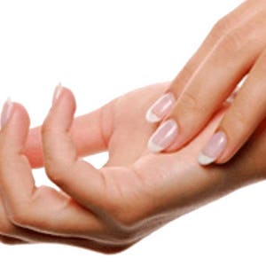 May include: Close-up of a person's hands with manicured nails. The nails are painted with a clear polish and have a white tip.