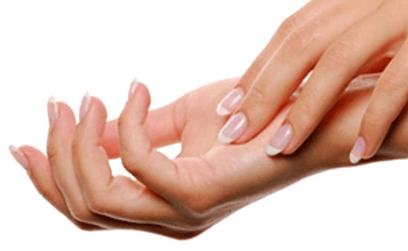 May include: Close-up of a person's hands with manicured nails. The nails are painted with a clear polish and have a white tip.