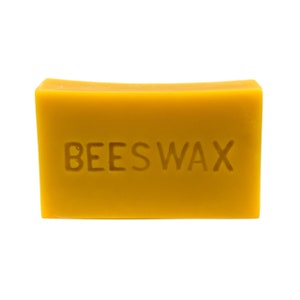 May include: A block of yellow beeswax with the word "BEESWAX" embossed on the front.