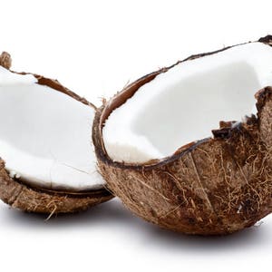 May include: Two halves of a brown coconut with the white flesh visible inside. The coconuts are sitting on a white background.