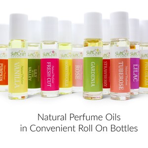 May include: A set of 10 natural perfume oils in roll-on bottles. The bottles are labeled with the scents: Pumpkin Spice, Vanilla, Lily of the Valley, Fresh Cut, Honeysuckle, Rose, Gardenia, Strawberry, Tuberose, Lilac, and Pina Colada.