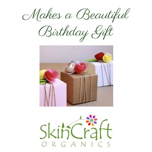 May include: Three gift boxes wrapped in brown, white, and pink paper with twine and topped with pink paper flowers. The boxes are arranged on a white surface. The text "Makes a Beautiful Birthday Gift" is above the boxes and the text "SkinCraft Organics" is below the boxes.