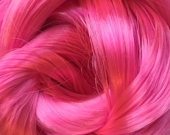May include: A close-up of a bright pink yarn, showing the individual strands of the yarn.