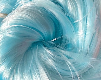 May include: A close-up of a bundle of light blue fishing net.