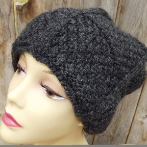 May include: A dark gray knitted beanie hat with a slouchy fit.