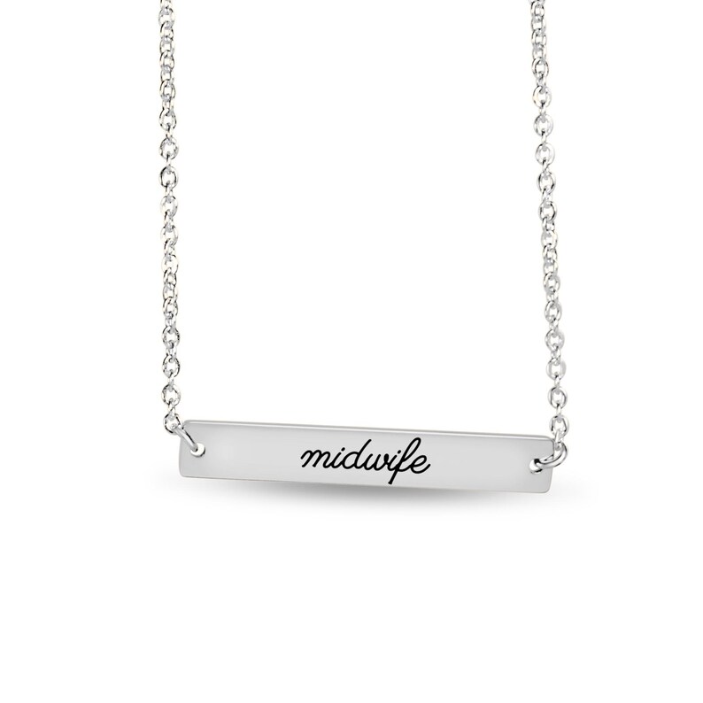 May include: A silver-toned bar necklace featuring a delicate chain and a horizontal rectangular pendant. The pendant is engraved with the word midwife in a black cursive script font, centered on the smooth, polished metallic surface.