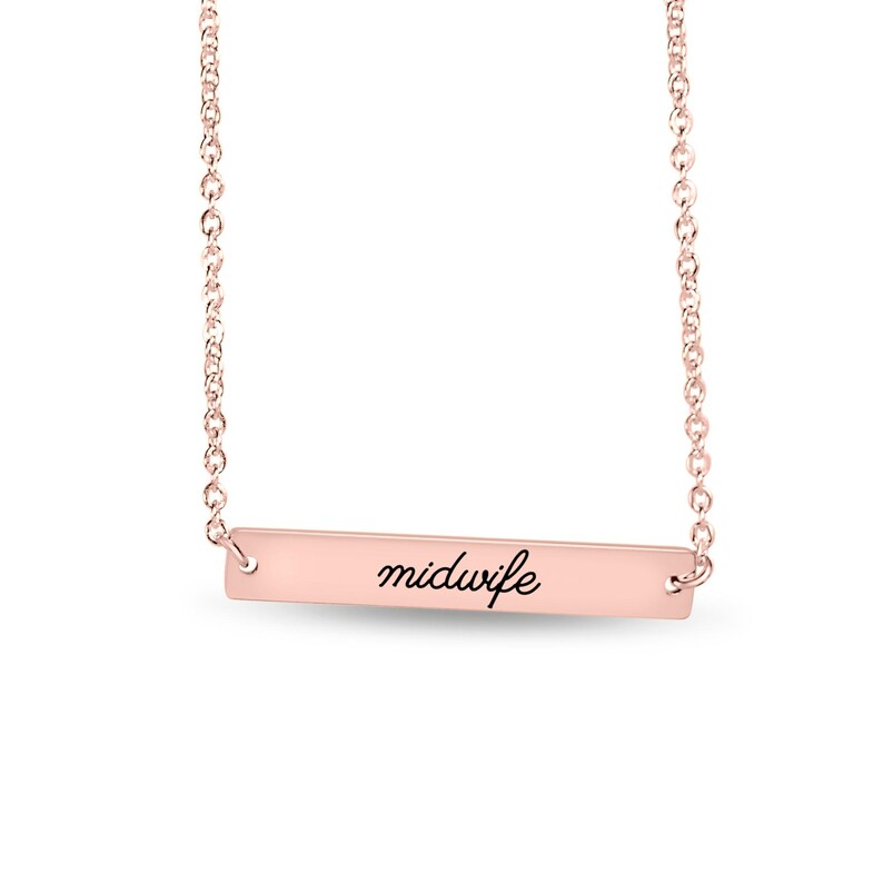 May include: A rose gold-toned metal bar necklace featuring a delicate chain and a horizontal rectangular pendant. The pendant is engraved with the word midwife in a black cursive script font, centered on the smooth metallic surface.