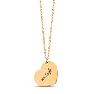May include: A gold-colored necklace featuring a heart-shaped pendant. The pendant has the word midwife engraved in a black cursive script font. The necklace consists of a delicate gold-colored chain attached to the top of the heart charm.