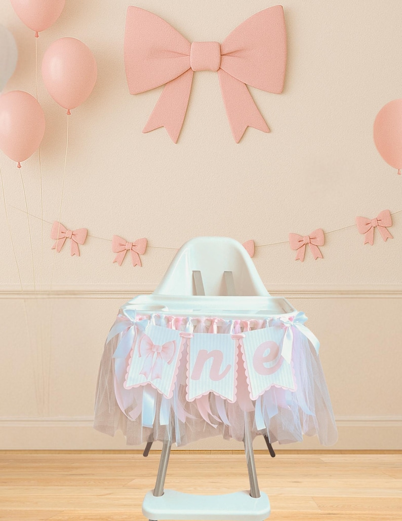 May include: A high chair decorated for a first birthday celebration. The chair has a pink and white banner that says "one". The chair is decorated with a pink tulle skirt and is surrounded by pink balloons and bow decorations.