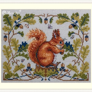 May include: A cross-stitch pattern featuring a red squirrel sitting on a tree stump surrounded by green leaves and acorns. The background is a light blue fabric with a white border.