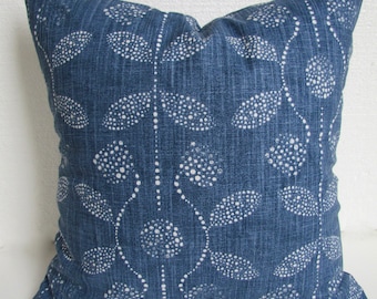 May include: A blue throw pillow with a white leaf pattern. The pillow is made of a textured fabric and has a subtle sheen.