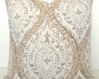May include: A decorative throw pillow with a beige, gray, and white damask pattern.