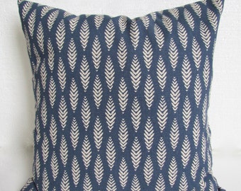 May include: A blue throw pillow with a white leaf pattern. The pillow is made of a soft, textured fabric.
