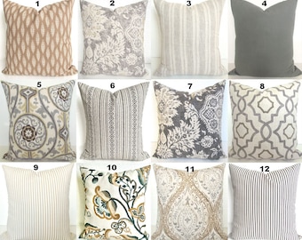 May include: Twelve different throw pillow designs featuring a variety of patterns and colors, including gray, beige, brown, and white. The pillows are arranged in a grid pattern.