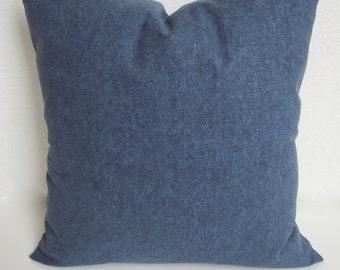 May include: A blue denim pillow cover with a subtle textured pattern. The pillow cover is square and has a simple design.