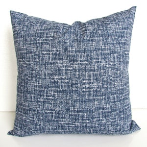 May include: A blue and white patterned throw pillow with a square shape.