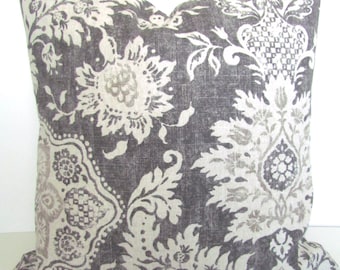 May include: A gray and white patterned throw pillow with a floral design.