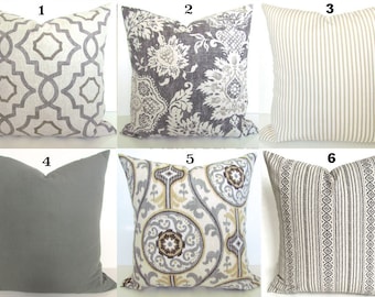 May include: Six different decorative throw pillows with various patterns and colors, including gray, beige, and white. The pillows are arranged in two rows of three.