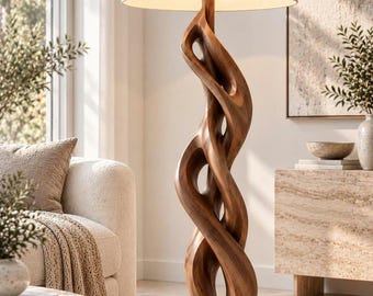 May include: A floor lamp featuring a tall, sculptural base carved from dark brown wood with a continuous, twisting, open-form design. The lamp is topped with a large, cylindrical, off-white fabric drum shade that emits a soft light.