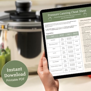 May include: A digital tablet displaying a pressure canning cheat sheet with a table listing vegetables, jar sizes, processing times, and pressure in PSI. The tablet is being held by a person's hands. The text "Instant Download Printable PDF" is visible in the lower left corner of the image.