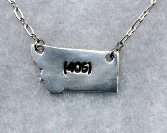 State of Montana - silver (406) pendant on a silver-plated chain.  18" with Lobster claw clasp.