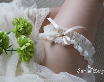 Liga de novia color marfil: fajín de gasa, liga de boda con lazo beige.