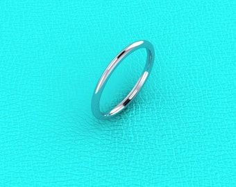 May include: A simple silver band ring, shown on a turquoise background.