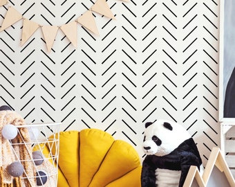 May include: A children's room decorated with a black and white chevron wallpaper. The room features a panda bear stuffed animal, a yellow crescent-shaped pillow, a wooden mountain-shaped shelf, a wooden toy truck, and a framed picture of two bears.