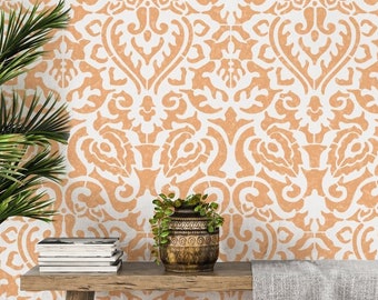 May include: A wooden bench with a light grey throw blanket sits in front of a wall with a white and orange damask pattern wallpaper. A potted plant sits on the bench.
