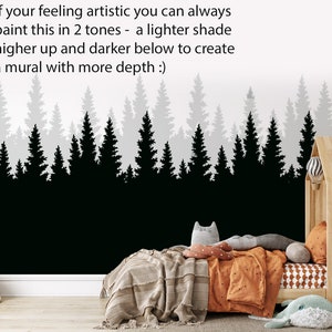 May include: Black and white silhouette of a forest with pine trees. The image is a wall mural design with text that reads "If your feeling artistic you can always paint this in 2 tones - a lighter shade higher up and darker below to create a mural with more depth :)"