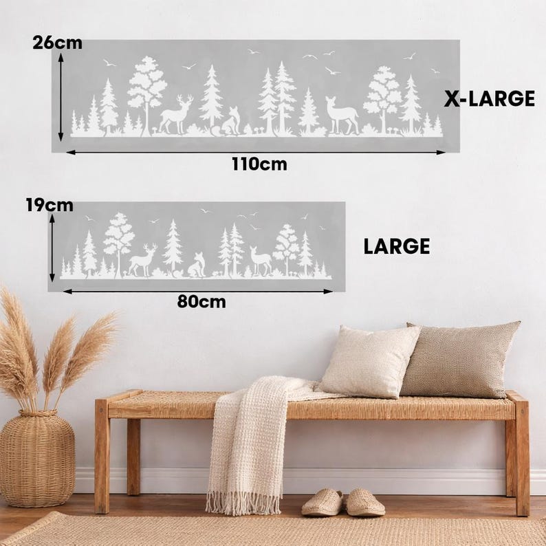 May include: Two gray wall decals with a white forest scene featuring trees, deer, and foxes. The larger decal is 43 inches wide and 10 inches tall, and the smaller one is 31 inches wide and 7.5 inches tall. Text on the image reads "X-LARGE" and "LARGE".