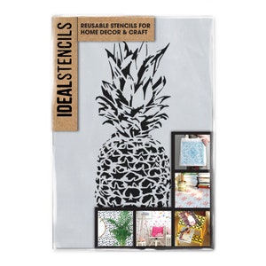 May include: Reusable stencil of a black pineapple on a white background. The stencil is packaged in a clear plastic sleeve with the text "IDEAL STENCILS" and "REUSABLE STENCILS FOR HOME DECOR & CRAFT".