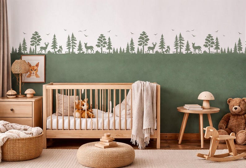May include: A nursery with a wooden crib, a framed fox picture, and a forest-themed wall mural. The room includes a teddy bear, a rocking horse, and a woven basket. The color scheme is neutral with green and wood tones.