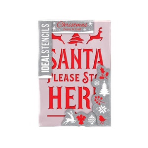 May include: A white stencil with red lettering that says "Santa Please Stop Here". The stencil is surrounded by a silver border and includes various Christmas-themed images, such as reindeer, snowflakes, and a Christmas tree.
