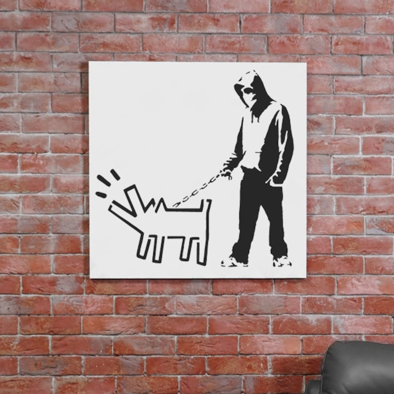 May include: Black and white stencil art print of a hooded figure walking a dog on a leash. The dog is a stylized cartoon dog with a long tail and a short body. The figure is wearing a hooded sweatshirt and pants.