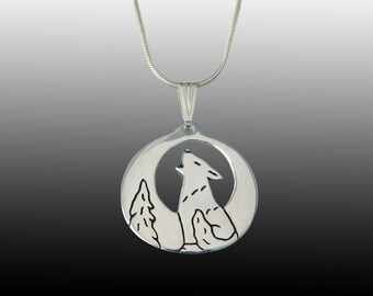 May include: A silver necklace with a round pendant featuring a wolf howling at the moon. The pendant is cut out to show the wolf and moon.