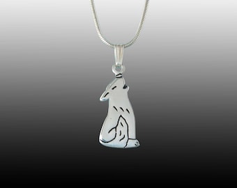 May include: A silver necklace with a wolf pendant. The wolf is howling and is in a sitting position. The necklace is on a white background.