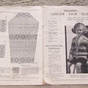May include: A vintage knitting pattern for a girl's cardigan with a chart method. The pattern features a geometric design with diamonds and triangles. The pattern is from Weldon's Junior Fair Isles.