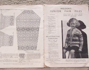 May include: A vintage knitting pattern for a girl's cardigan with a chart method. The pattern features a geometric design with diamonds and triangles. The pattern is from Weldon's Junior Fair Isles.