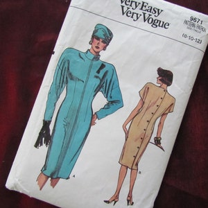 May include: A sewing pattern for two dresses, one in teal and one in beige. The pattern is called "Very Easy Very Vogue" and the pattern number is 9671. The size range is 8-10-12.