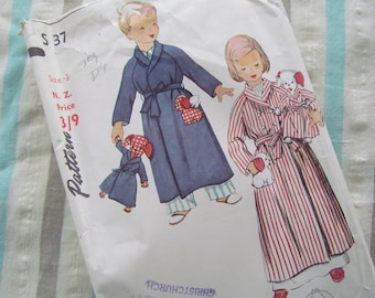 May include: Vintage sewing pattern for children's robes. The pattern shows two children wearing striped and solid blue robes, each holding a toy dog. The pattern number is S 37 and the price is 3/19.